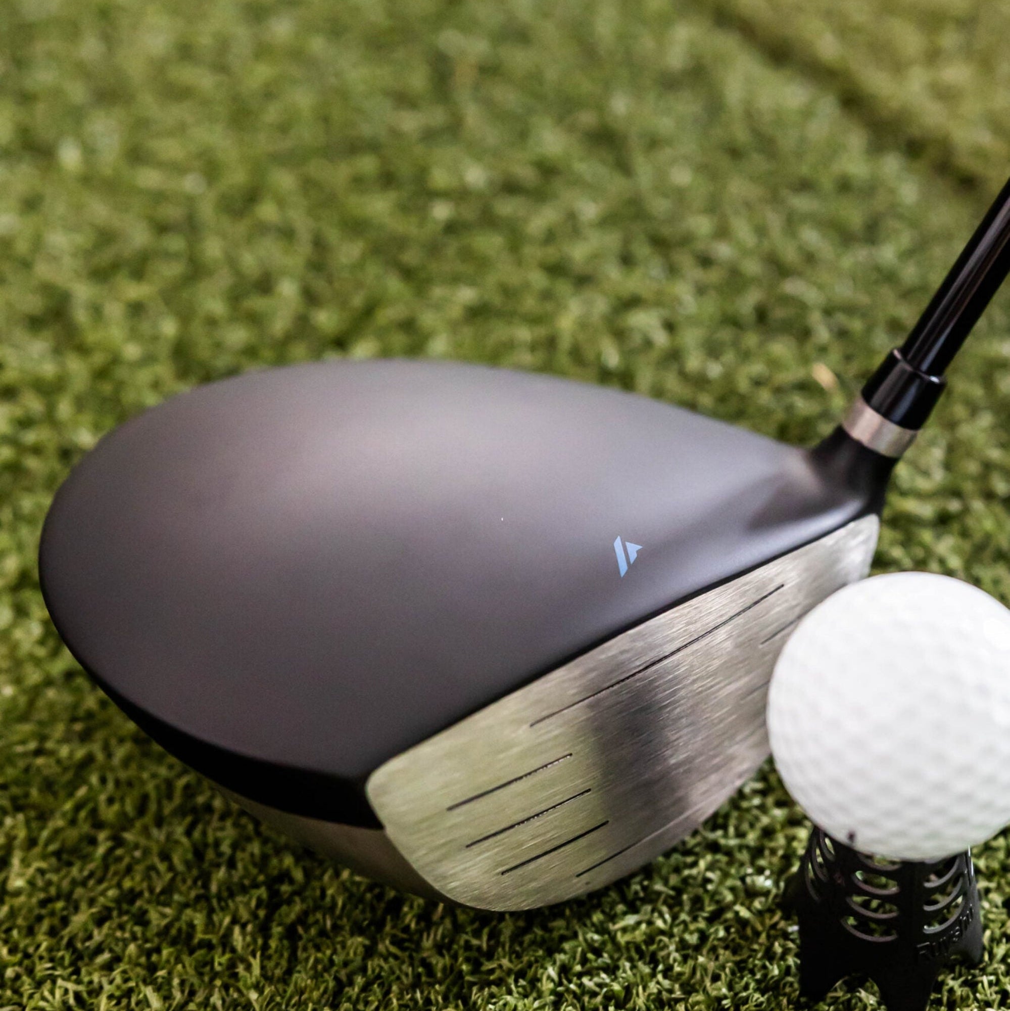 Golf club and ball on a grassy surface